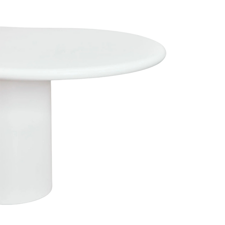 Close-up detail of the tabletop edge showing the smooth curved cement finish.