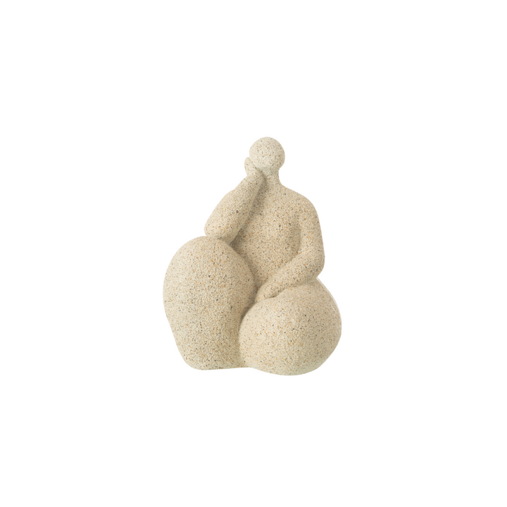 Beige resin figurative sculpture with rounded organic form on white background.