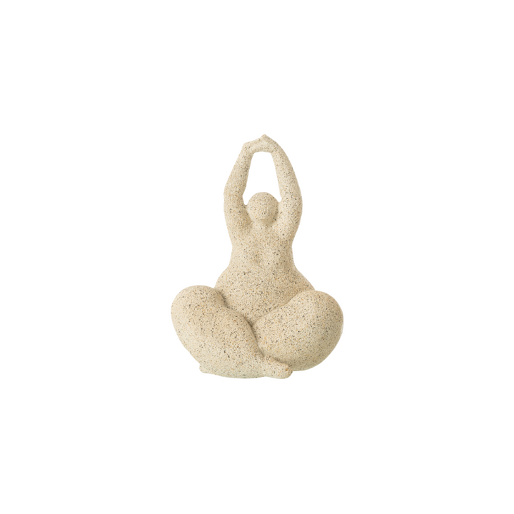 Beige resin figurative sculpture with rounded organic form on white background.