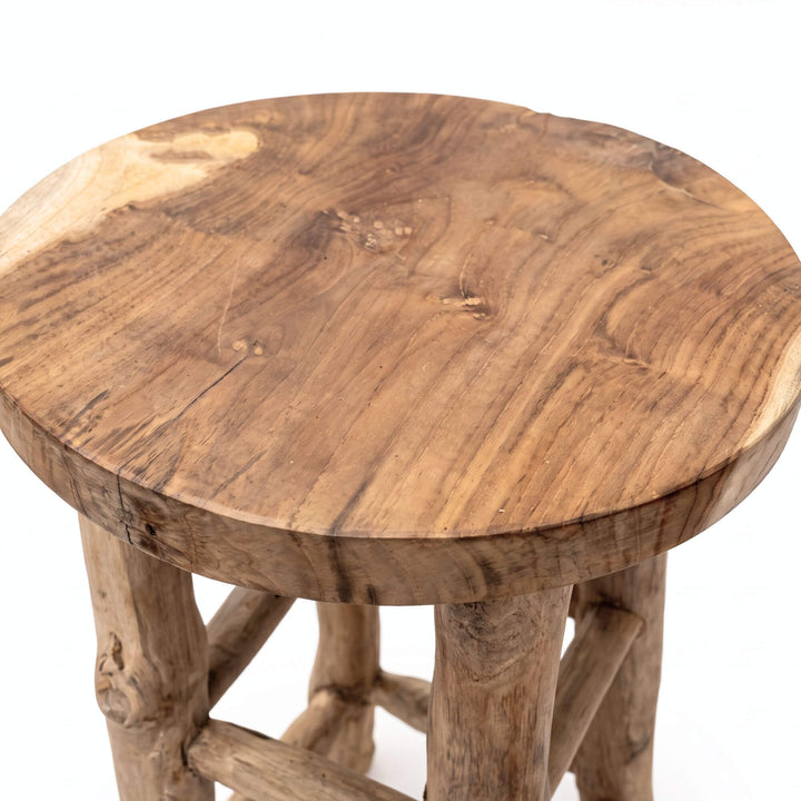 Close-up of the Osaka bar stool showing its round teak wood seat and organic branch structure