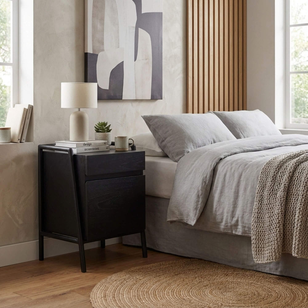 Modern bedroom with a bed, Otemanu nightstand, and abstract art on the wall.