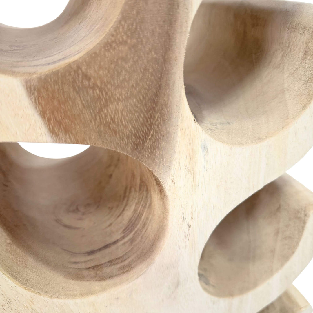 Close-up of Osiris Wine Rack showing carved suar wood grain and curved cradles