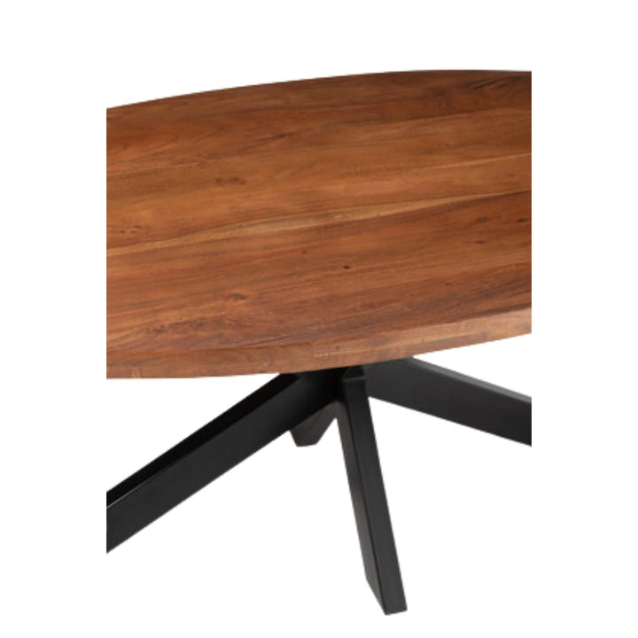 Top-down view of smooth acacia wood grain on oval dining table
