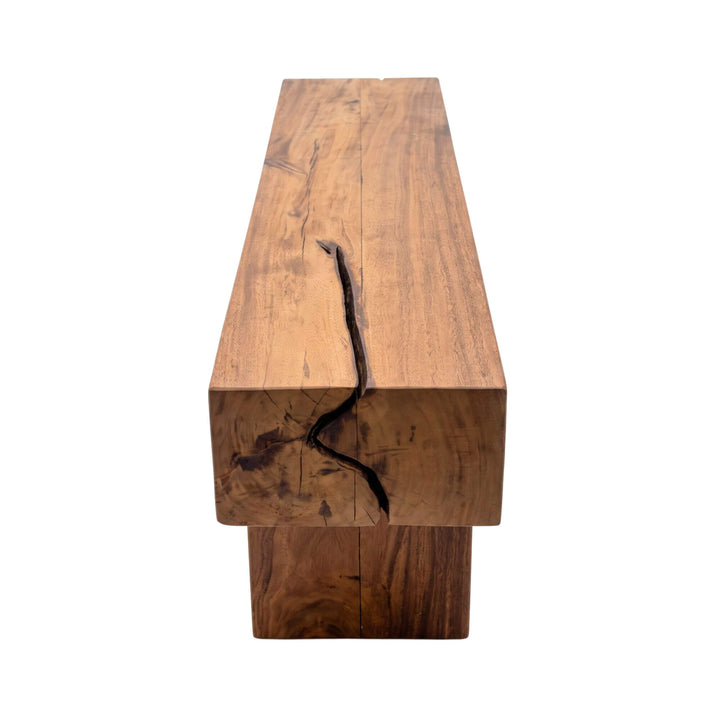 Side view of the Palawan coffee table highlighting the thick solid wood top, natural cracks, and substantial base