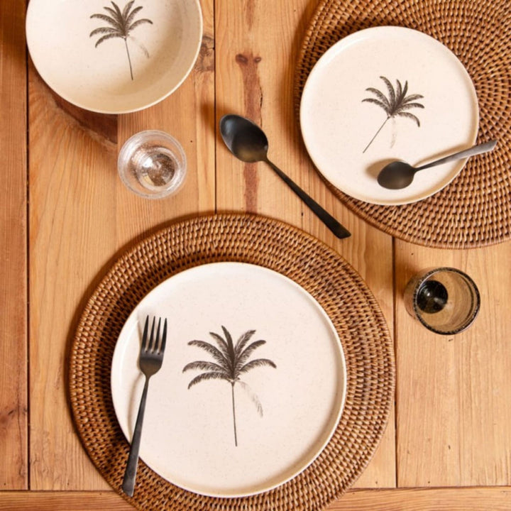 Overhead view of Palm ceramic tableware arranged on a warm wooden dining table