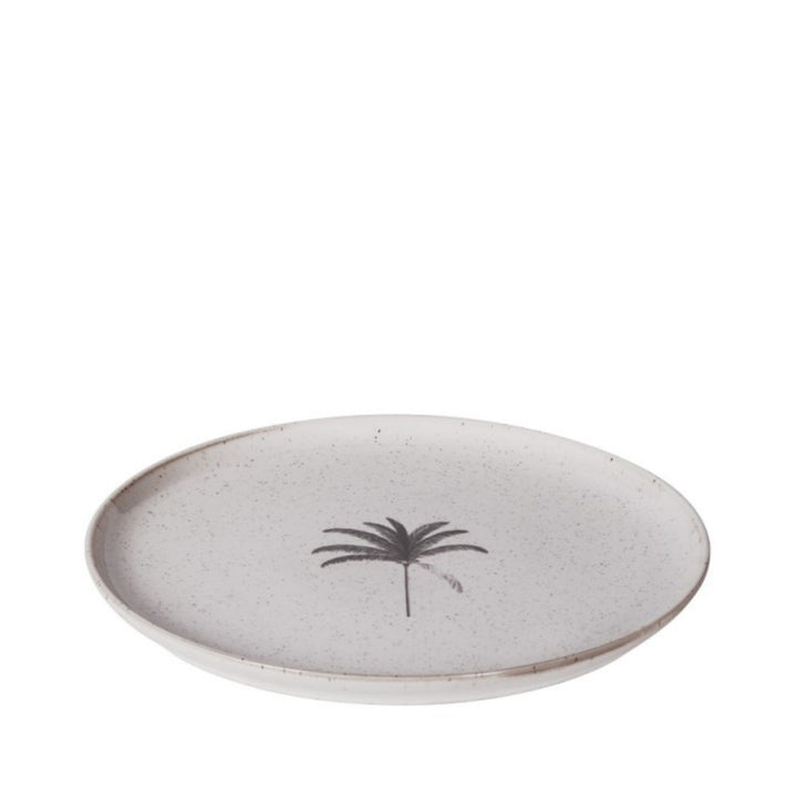 Angled side view of the Palm ceramic plate showing its softly speckled glazed surface