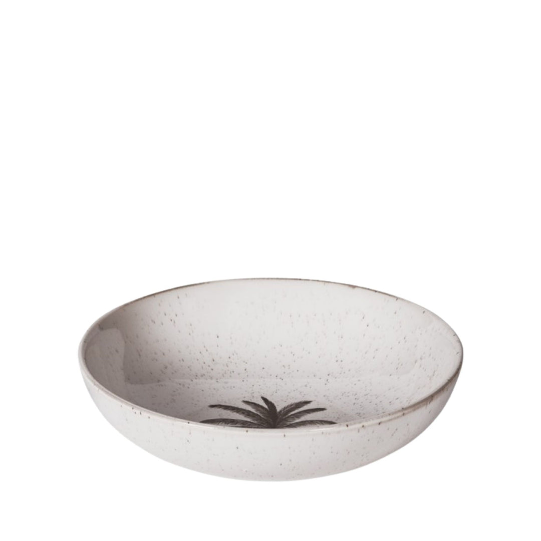 Angled view of the Palm ceramic serving bowl in softly speckled ivory
