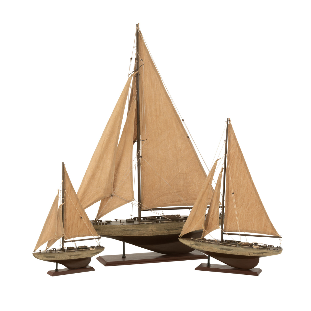 Decorative wooden sailboat with natural fabric sails displayed on white background.