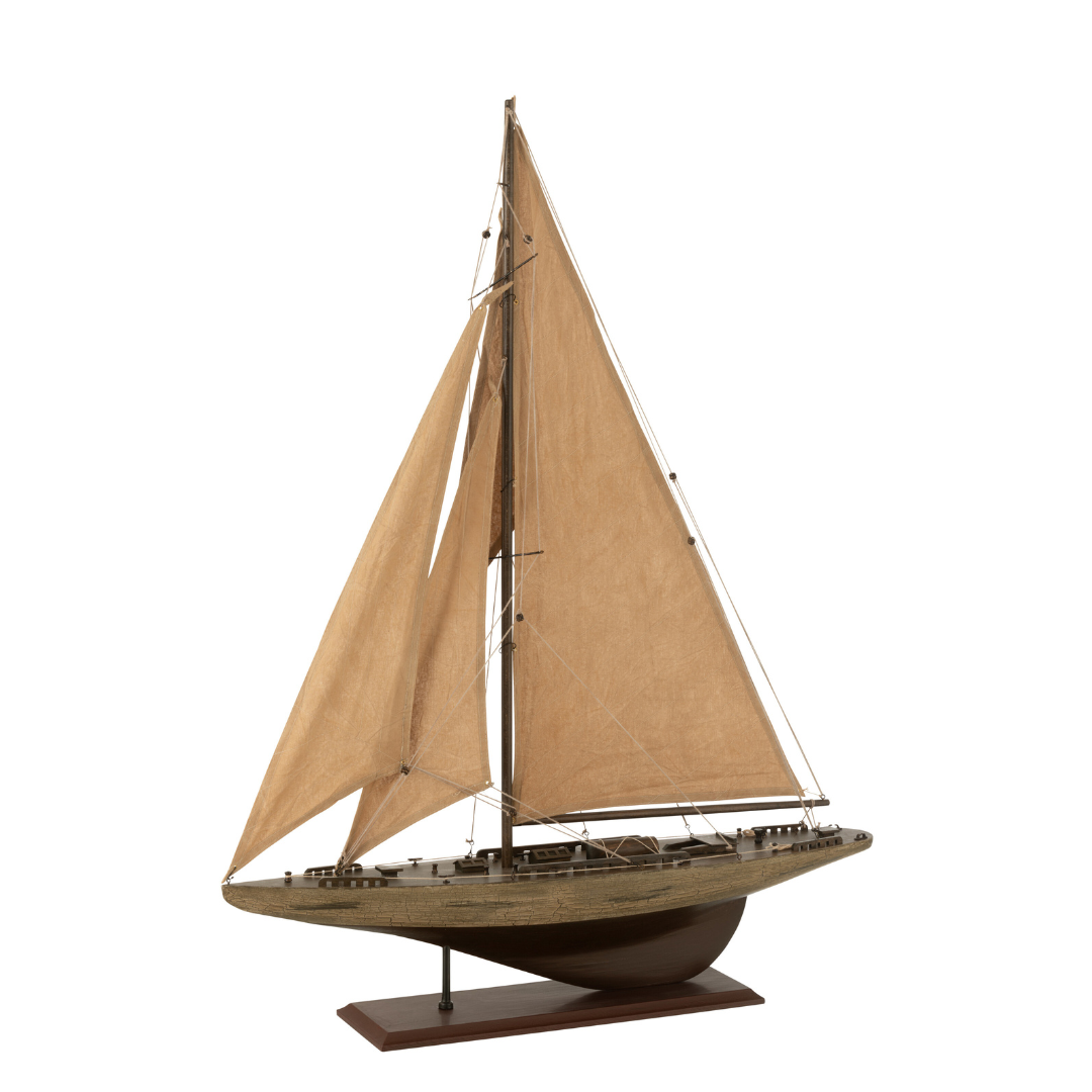 Paulownia wooden sailboat shown from a front angle with beige sails and wooden base.