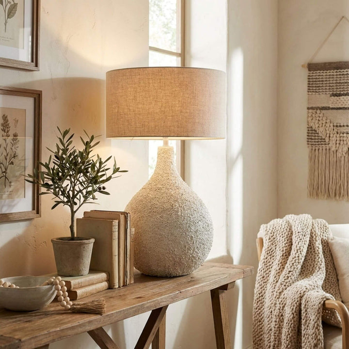 Styled interior setting featuring the Pemba lamp on a wooden console table with natural decor.