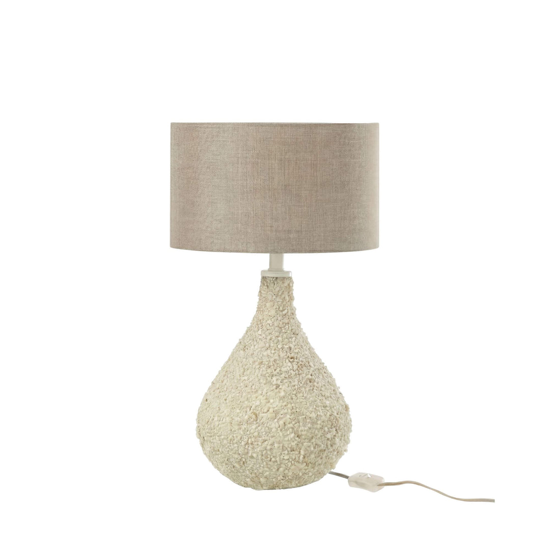 Full view of the table lamp highlighting its soft neutral tones and sculptural silhouette.