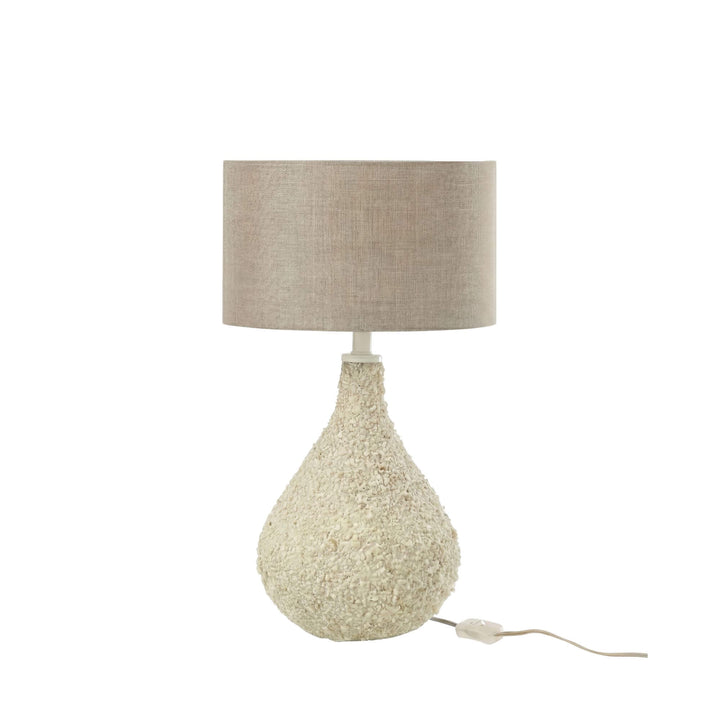 Full view of the table lamp highlighting its soft neutral tones and sculptural silhouette.