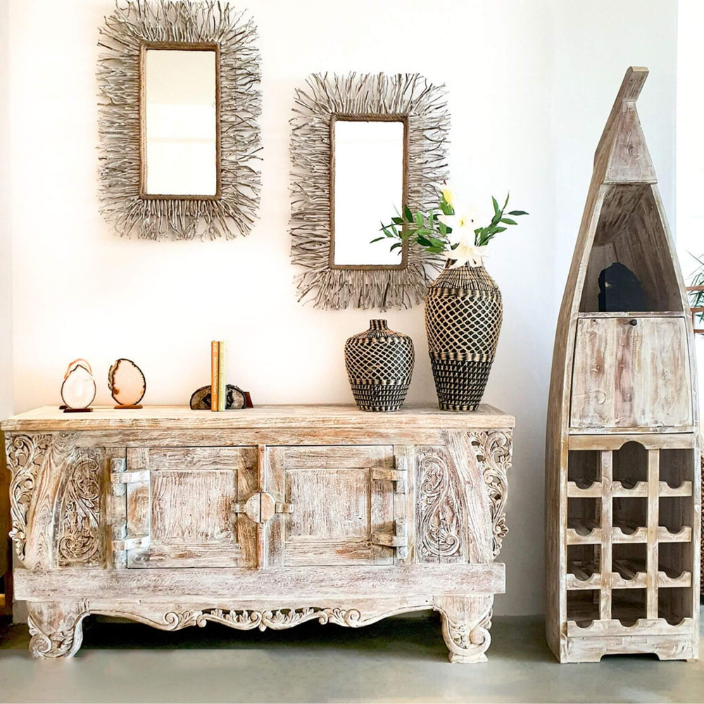 Interior setting featuring reclaimed teak bar beside rustic sideboard and mirrors