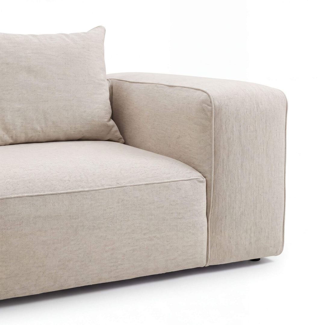 Detail view of the Positano chaise longue sofa showing its softly structured arm and generous seat cushion