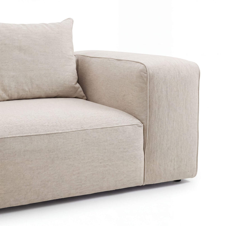 Detail view of the Positano chaise longue sofa showing its softly structured arm and generous seat cushion