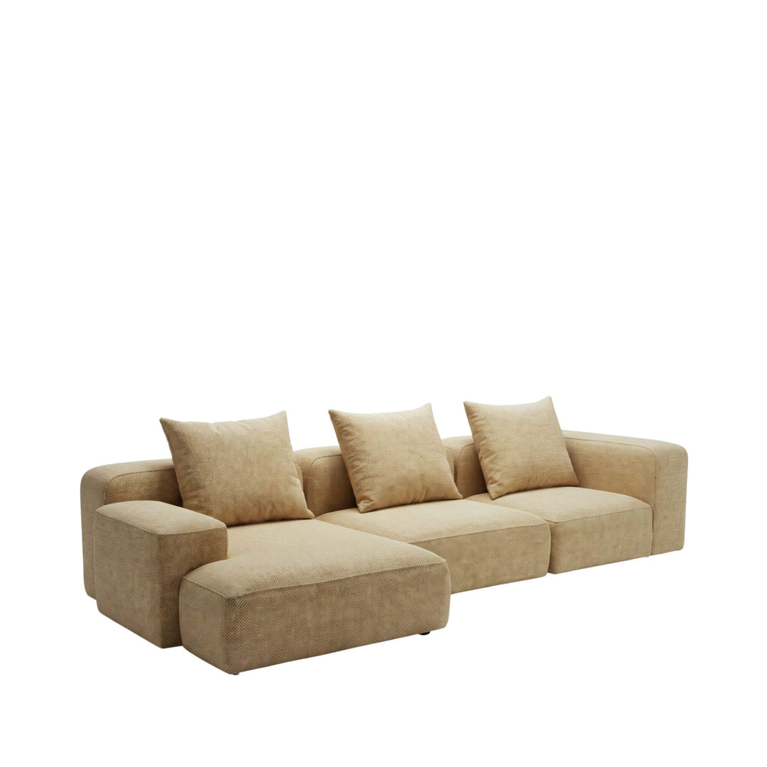 Front view of the Positano chaise longue sofa in a warm beige upholstery with extended lounging section