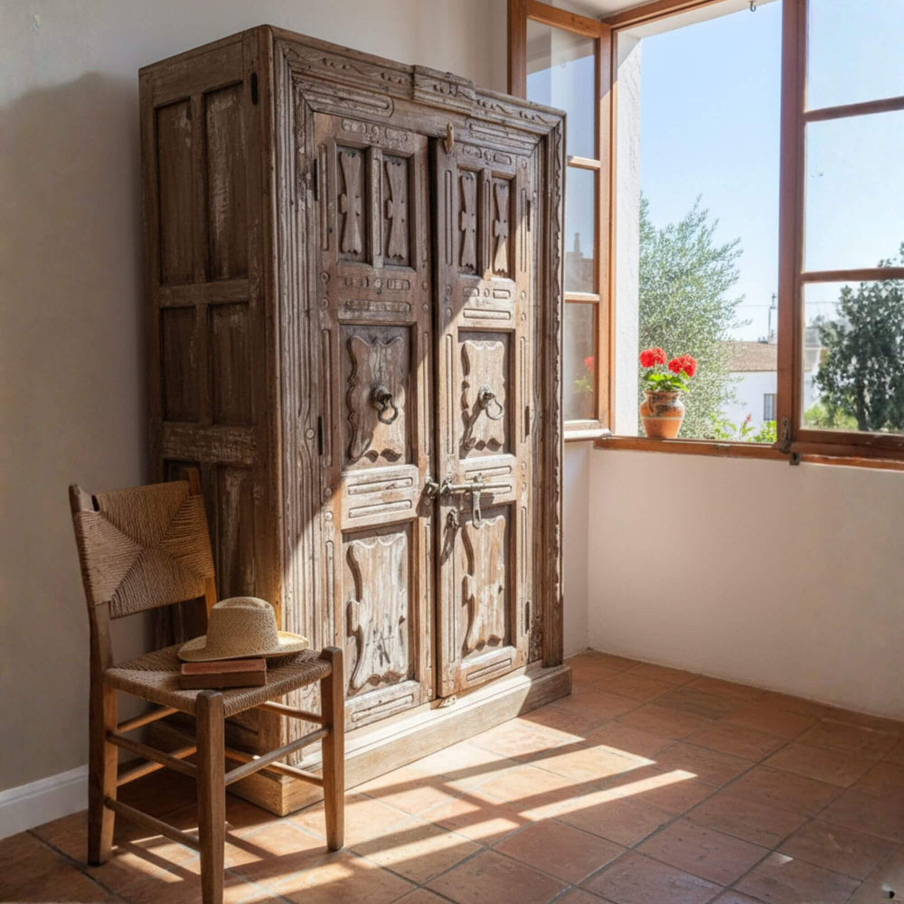 Bright interior scene showcasing the Pradesh wardrobe beside a wooden chair.
