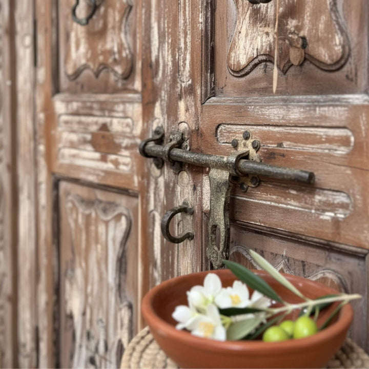 Close-up of the carved panels and aged finish on the sheesham wardrobe.