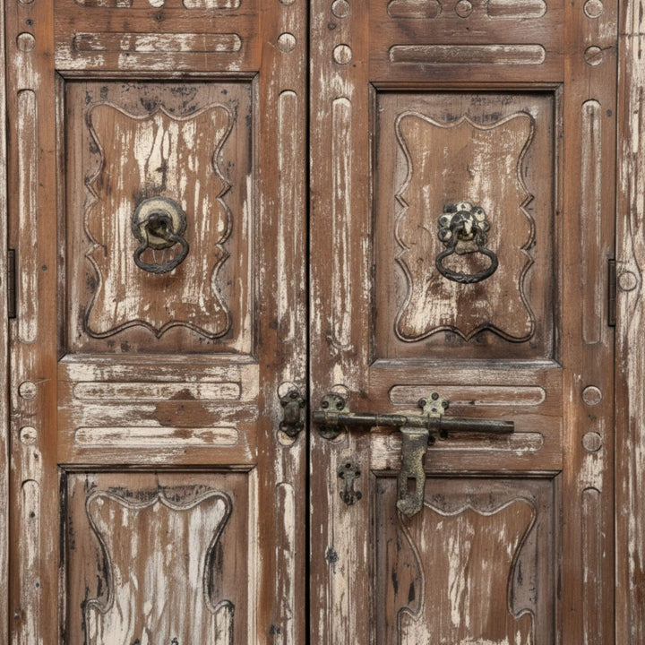 Close-up of the carved panels and aged finish on the sheesham wardrobe.