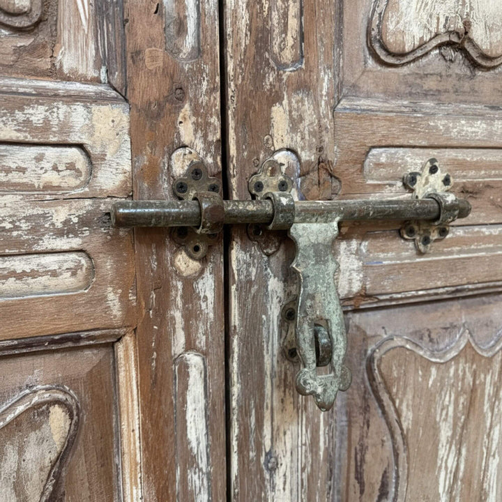 Close-up of the rustic iron latch and distressed wood texture.
