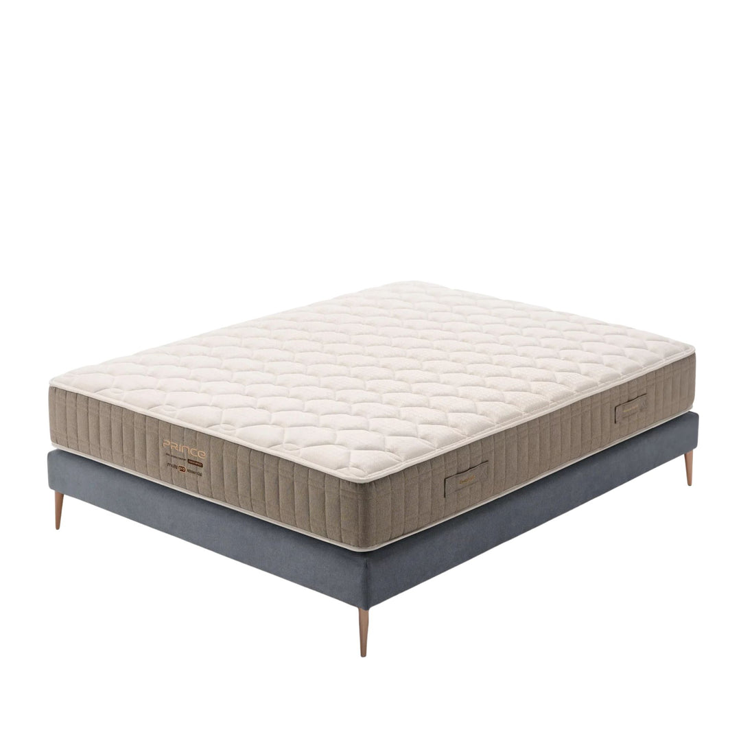 Prince Mattress in a styled bedroom setting showing its quilted top and elegant side panels.