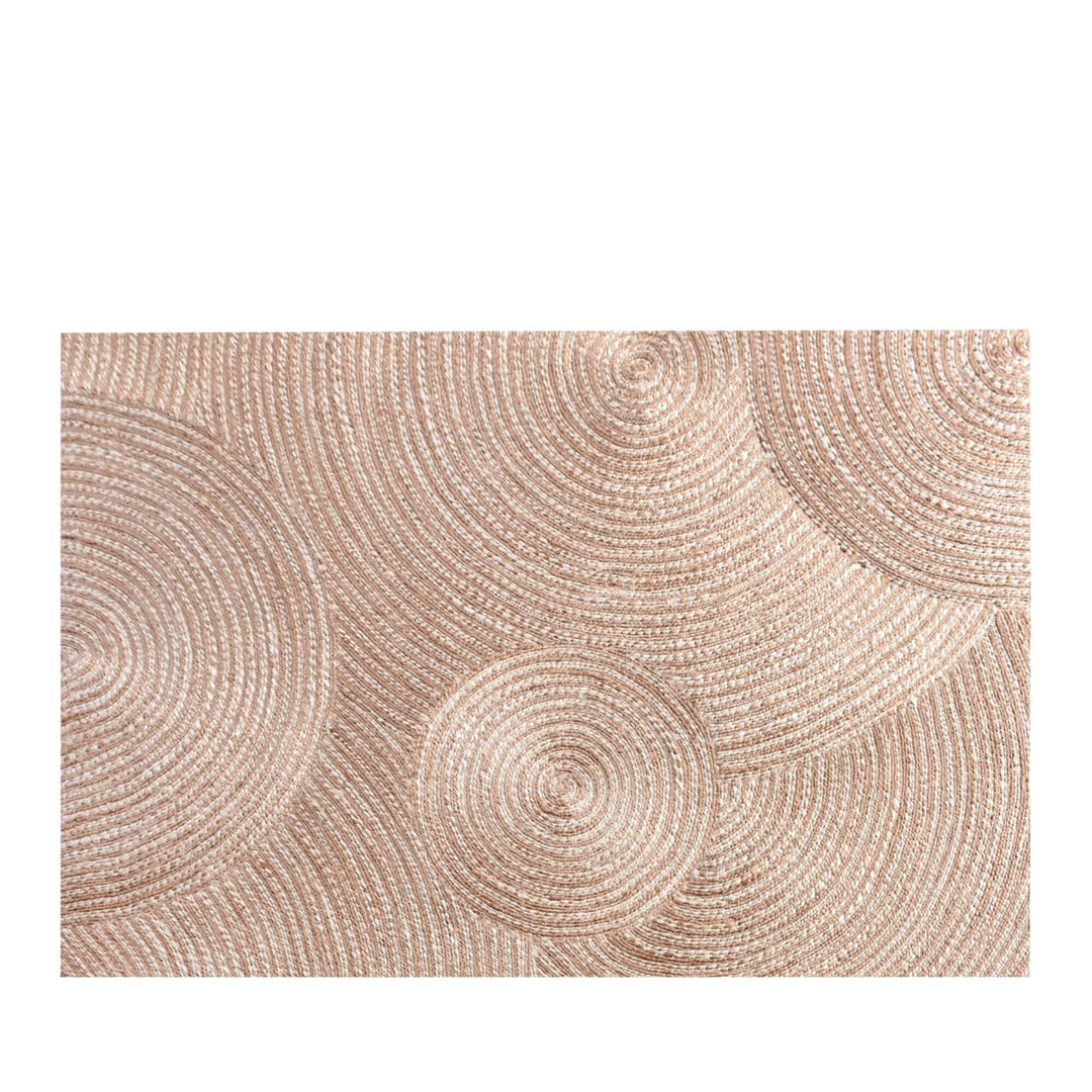 Front view of the Pudunta Rug showing circular woven patterns in natural jute tones.