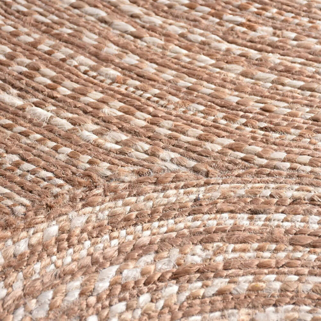 Close-up of the Pudunta Rug highlighting the spiral weave texture and natural fibers.