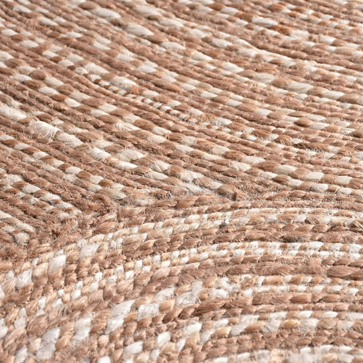 Close-up of the Pudunta Rug highlighting the spiral weave texture and natural fibers.
