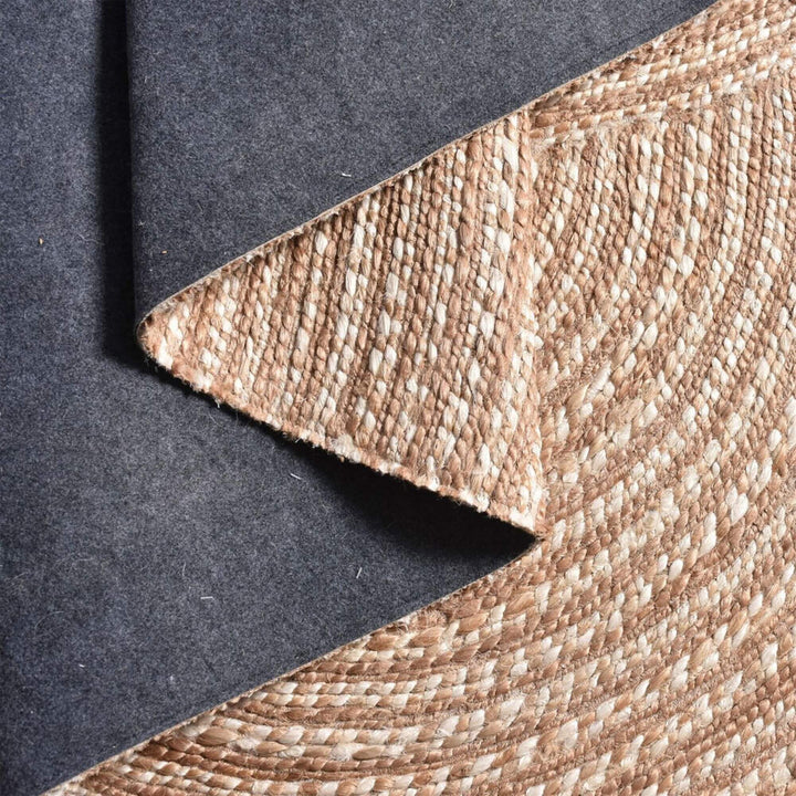 Corner detail view showing the thickness and handwoven structure of the Pudunta jute rug.