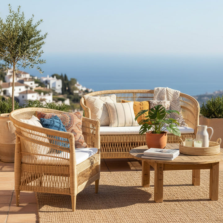 Outdoor terrace setup featuring the Punta Blanca rattan and teak chair.
