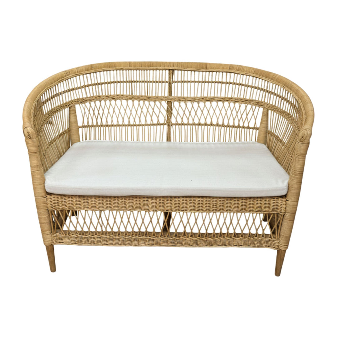 Angled view of the Punta Blanca Sofa showing its curved rattan backrest.