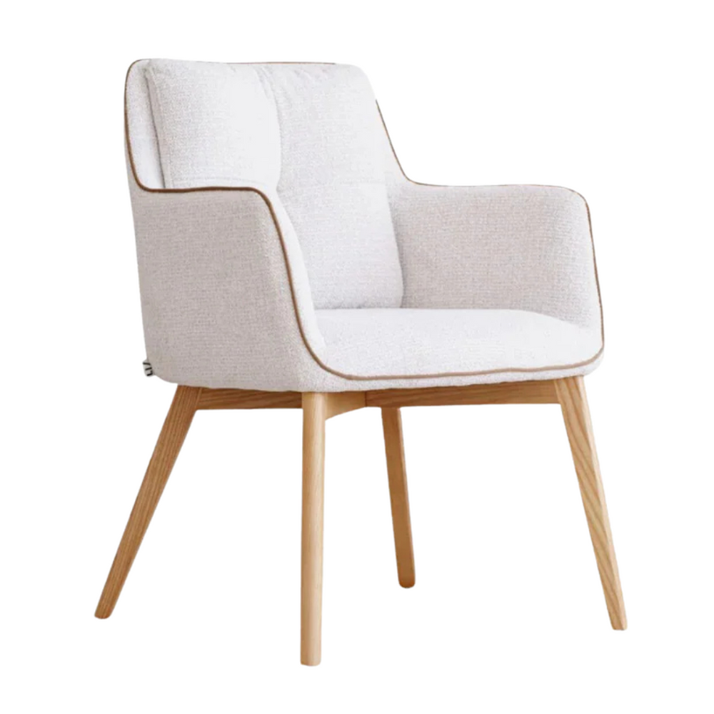 Angled ivory dining chair with cushioned seat and armrests.