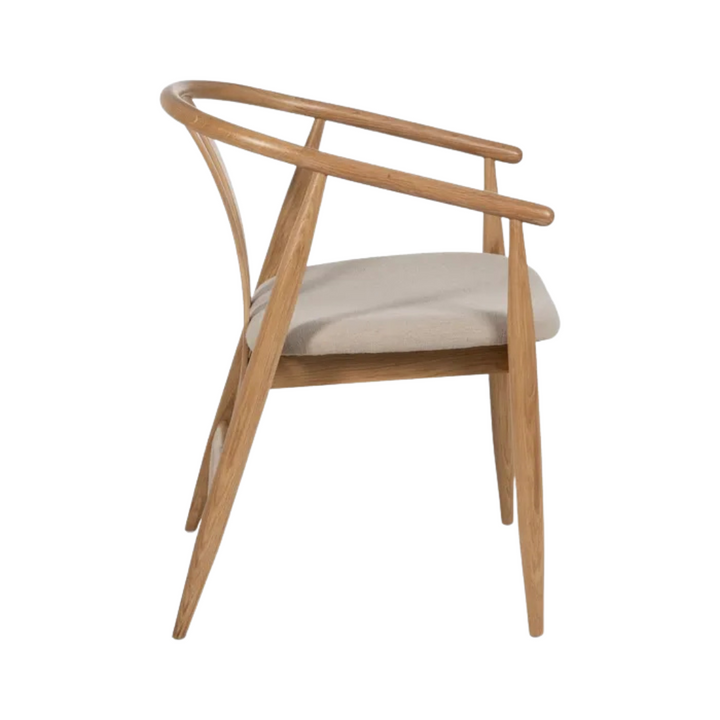 Side profile of Rabat oak dining chair showing oak frame and upholstered cushion