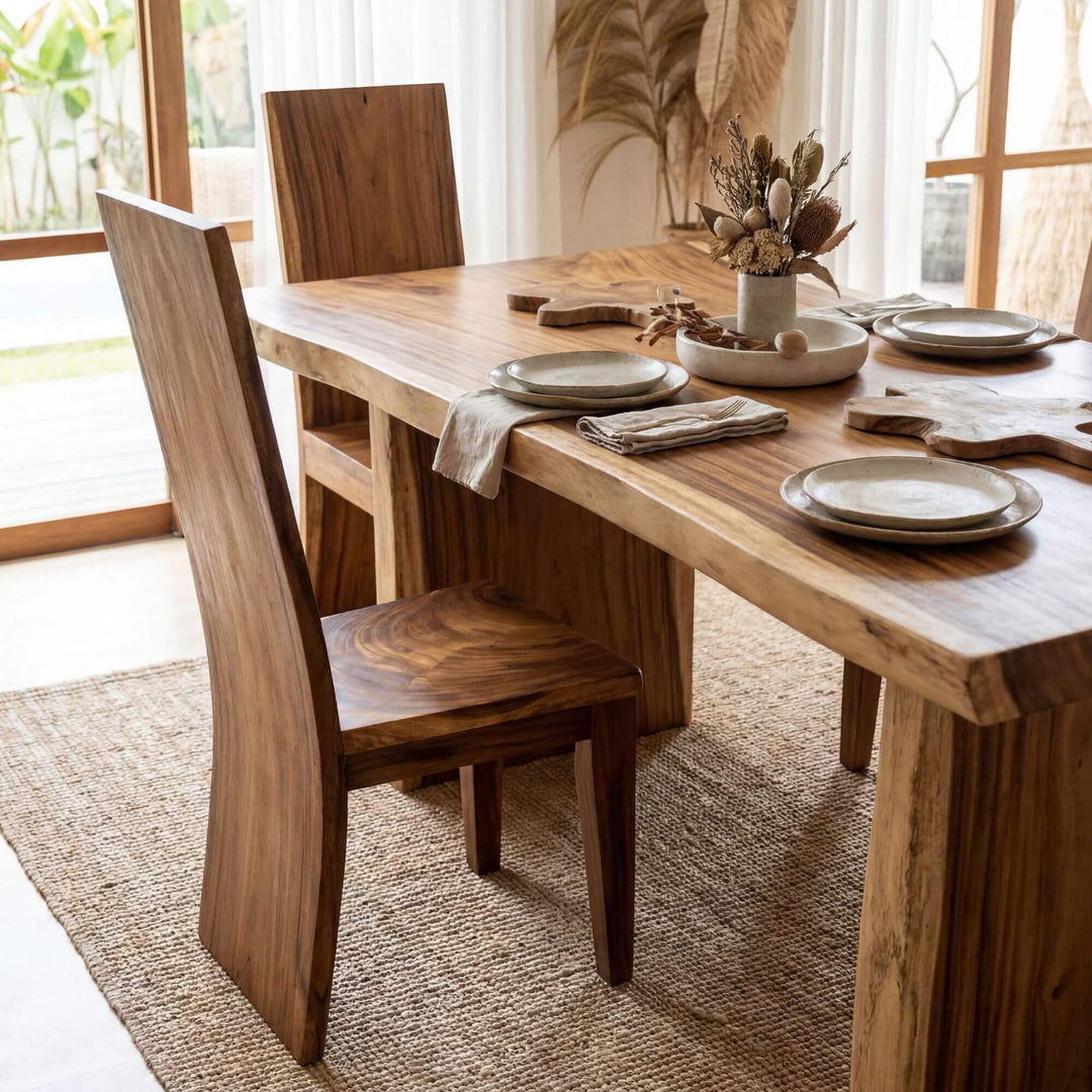 Styled dining room setting featuring Raja Ampat suar wood chairs around a matching wooden table.