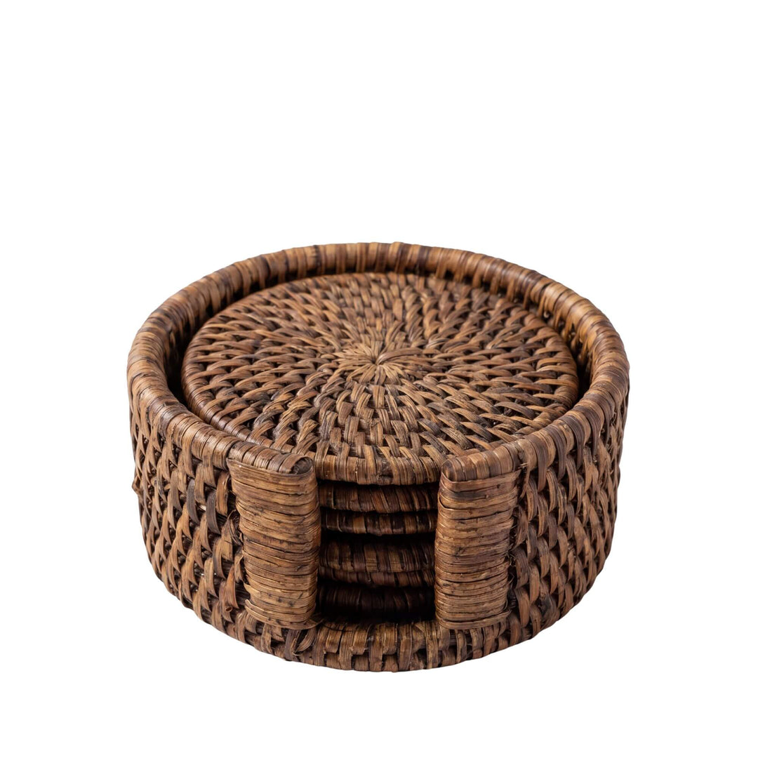 Front view of the rattan coaster set showing six round handwoven coasters in a matching holder.