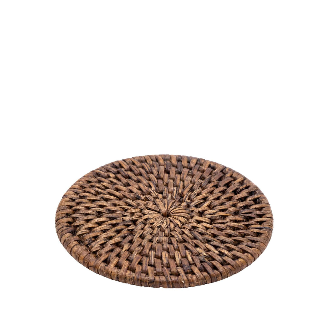 Angled view of a single coaster highlighting its slim profile and handwoven rattan finish.