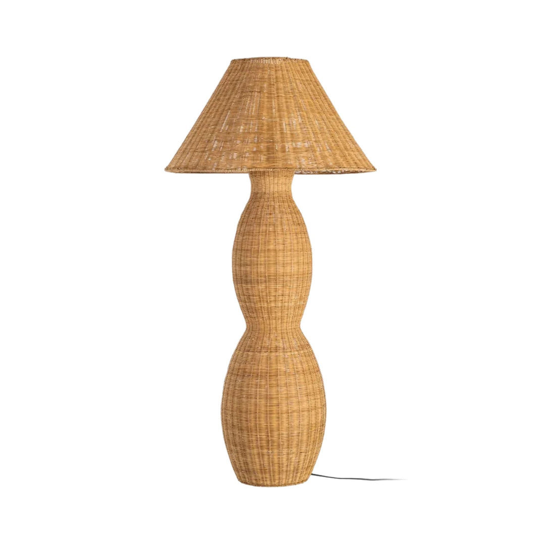 Front view of the rattan floor lamp showing its sculptural woven base and wide shade.