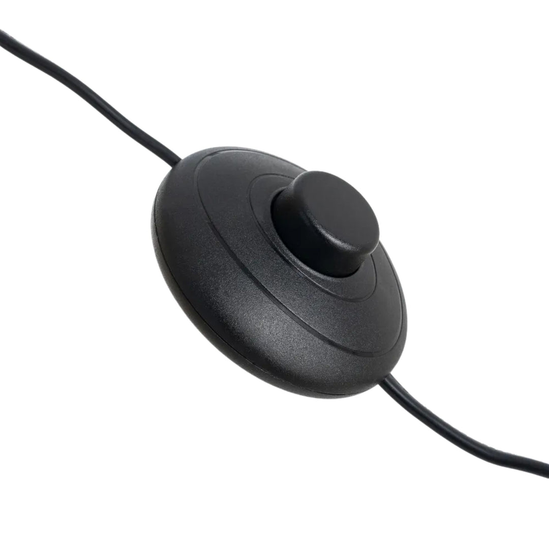 Close-up of the black floor switch and cable of the rattan floor lamp.