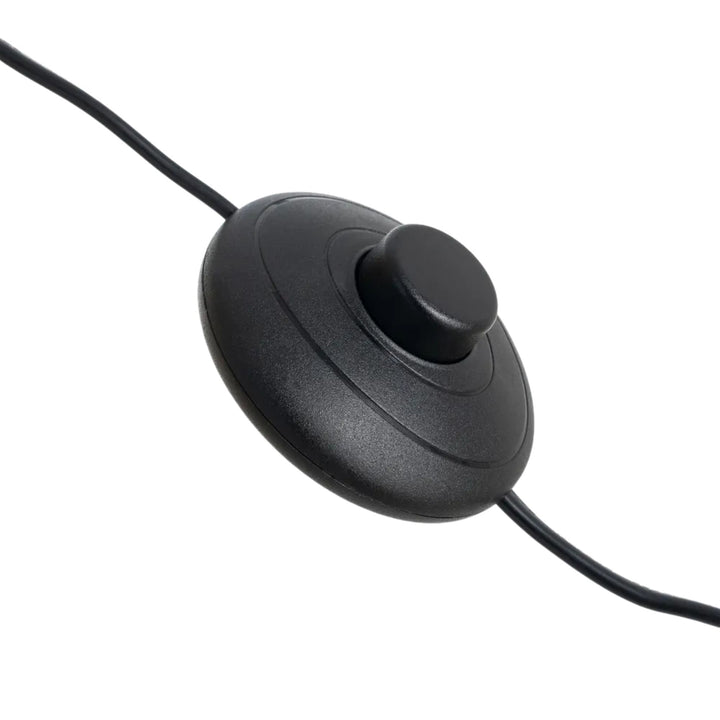 Close-up of the black floor switch and cable of the rattan floor lamp.
