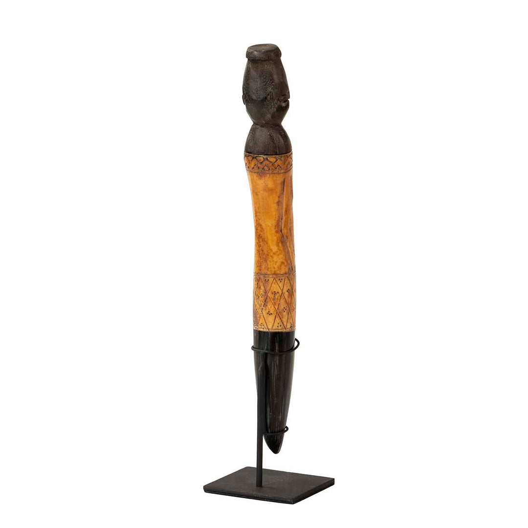 Back view of the wooden stand figure showing its slender sculptural form.