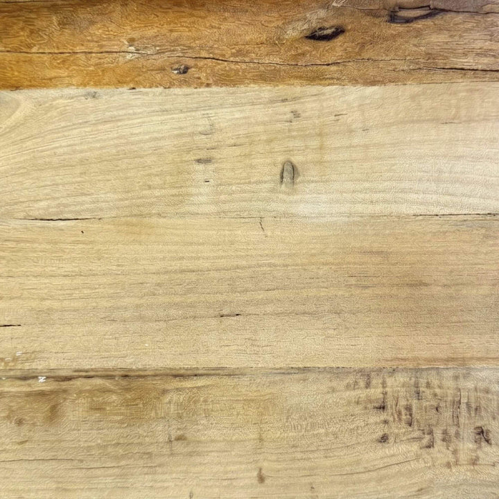 Close-up detail of the wood surface showing the reclaimed grain, texture, and natural tonal variation.