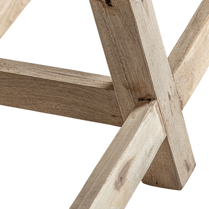 Close-up of a wooden geometric structure with intersecting beams on a white background