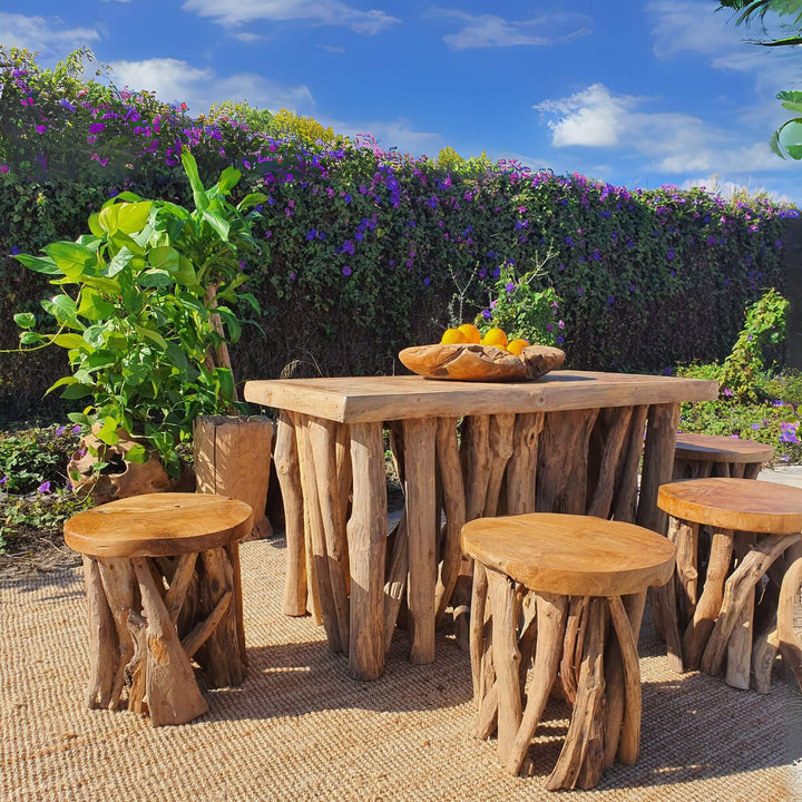 “Rimatara Teak Root Coffee Table styled in a tropical garden setting.”