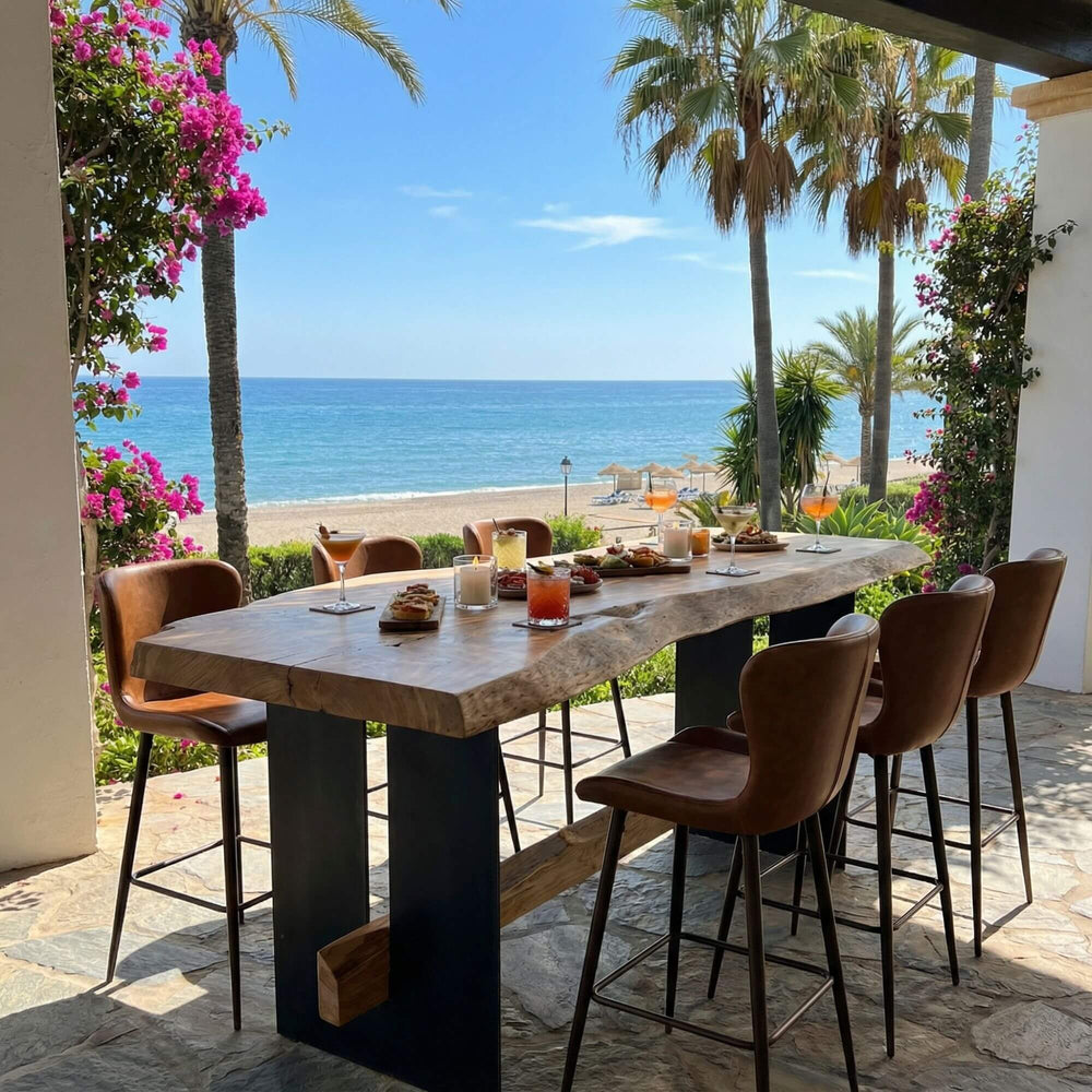 Outdoor Rimba bar table with bar chairs by the ocean