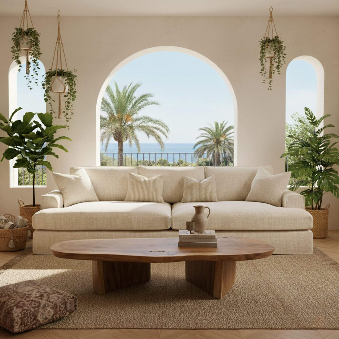 Living room with a beige Rimini sofa, wooden coffee table, and plants.