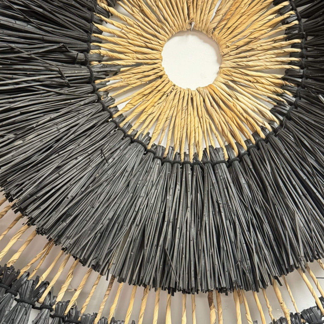 Close-up of the layered black and natural fibers of the Roda wall deco.