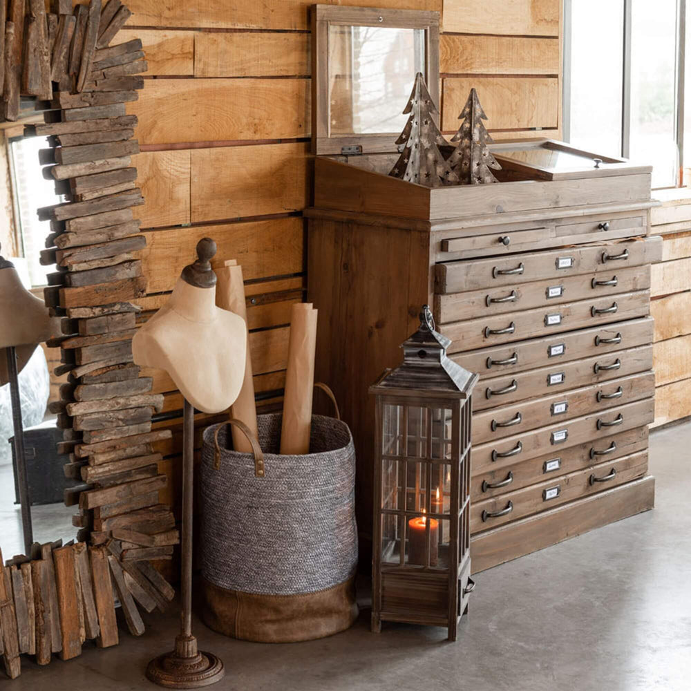Styled interior setting featuring the Roman lantern adding warm ambient light beside wooden furniture.