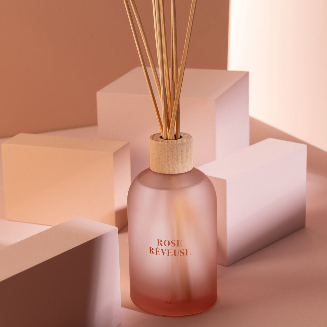 Close-up of the Rose Rêveuse Diffuser showing the frosted glass and reed sticks.