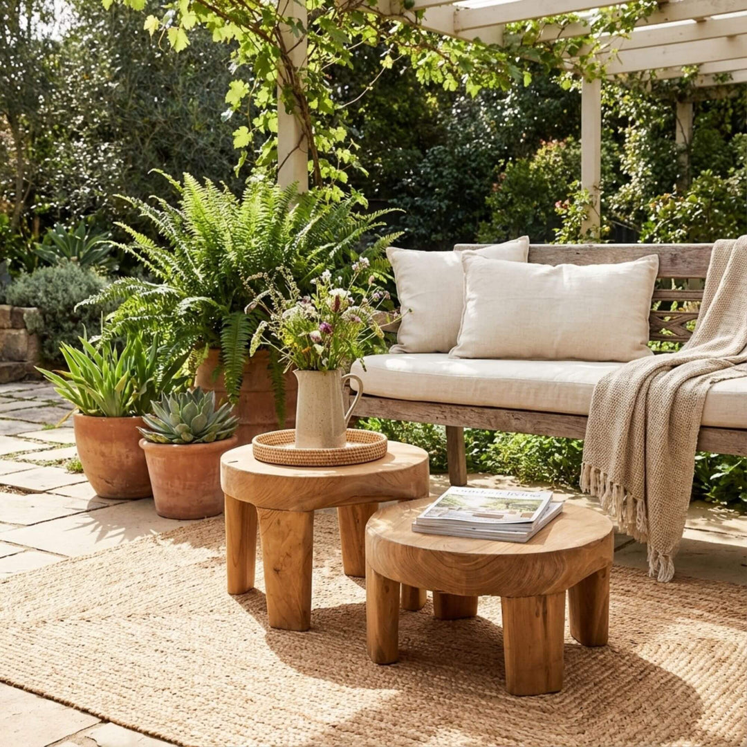 Styled outdoor view of Rurutu Coffee Tables arranged together on a terrace, highlighting their organic form.