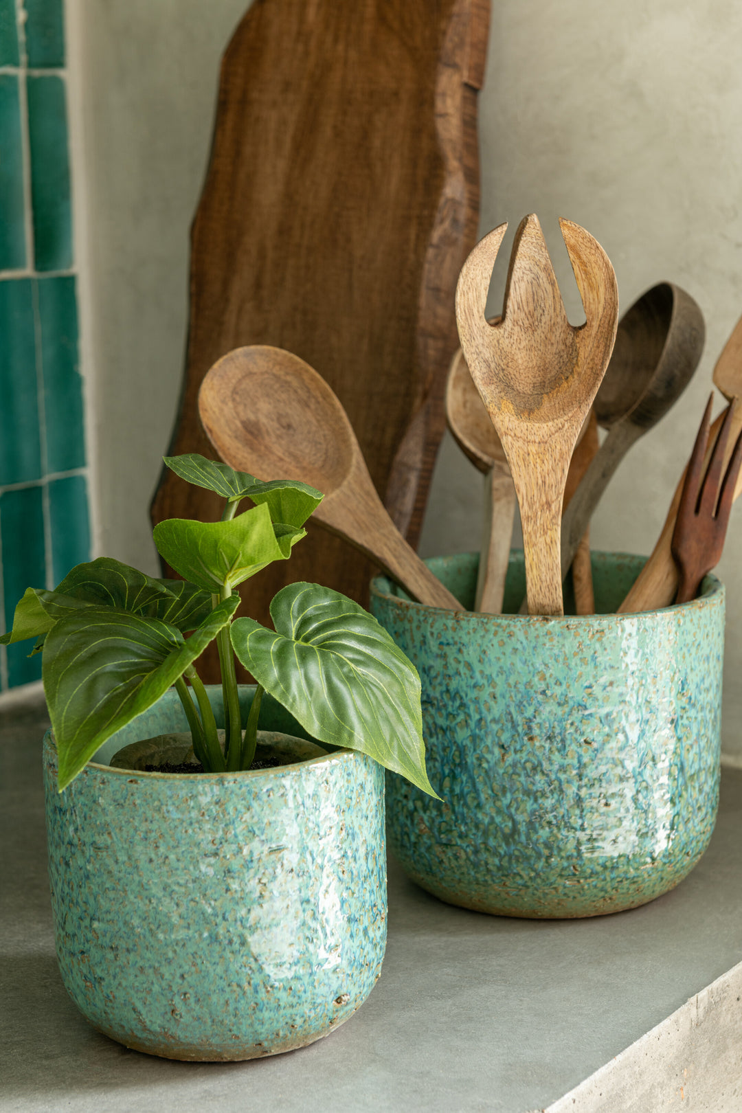 Styled interior scene featuring rustic ceramic pots as decorative planters.